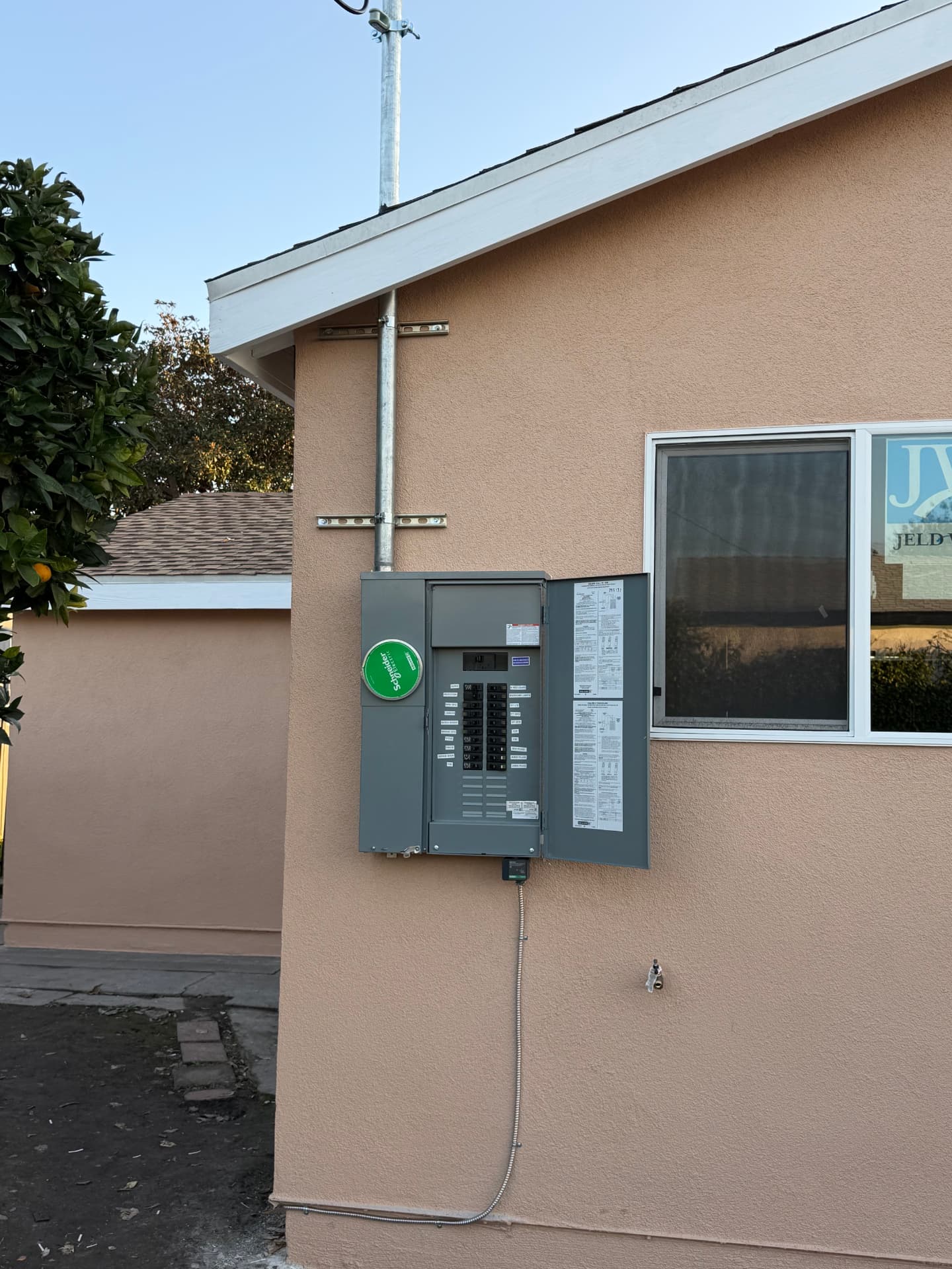Exterior service panel and conduit riser